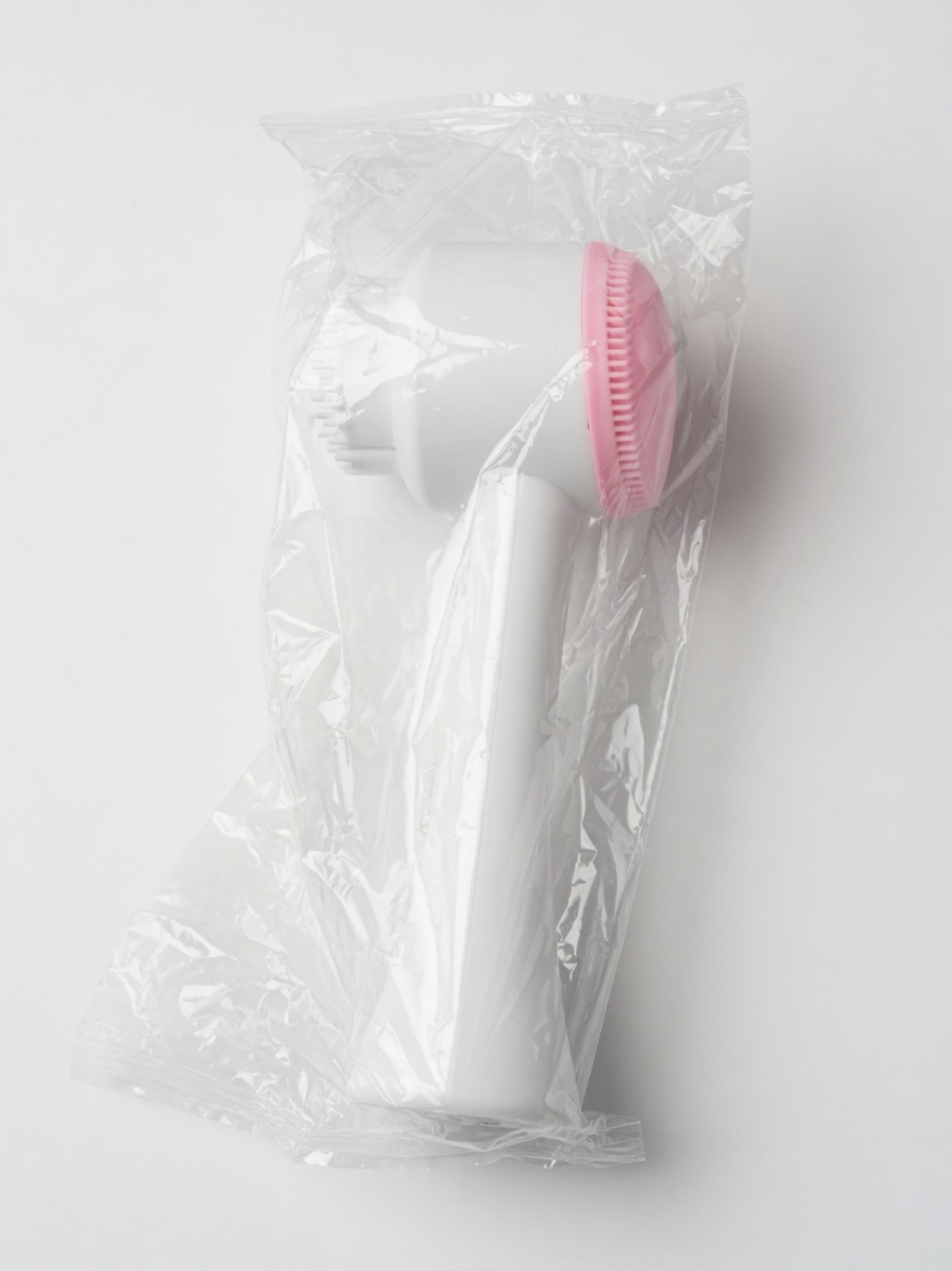 Free dual-sided silicone cleansing brush on a black background